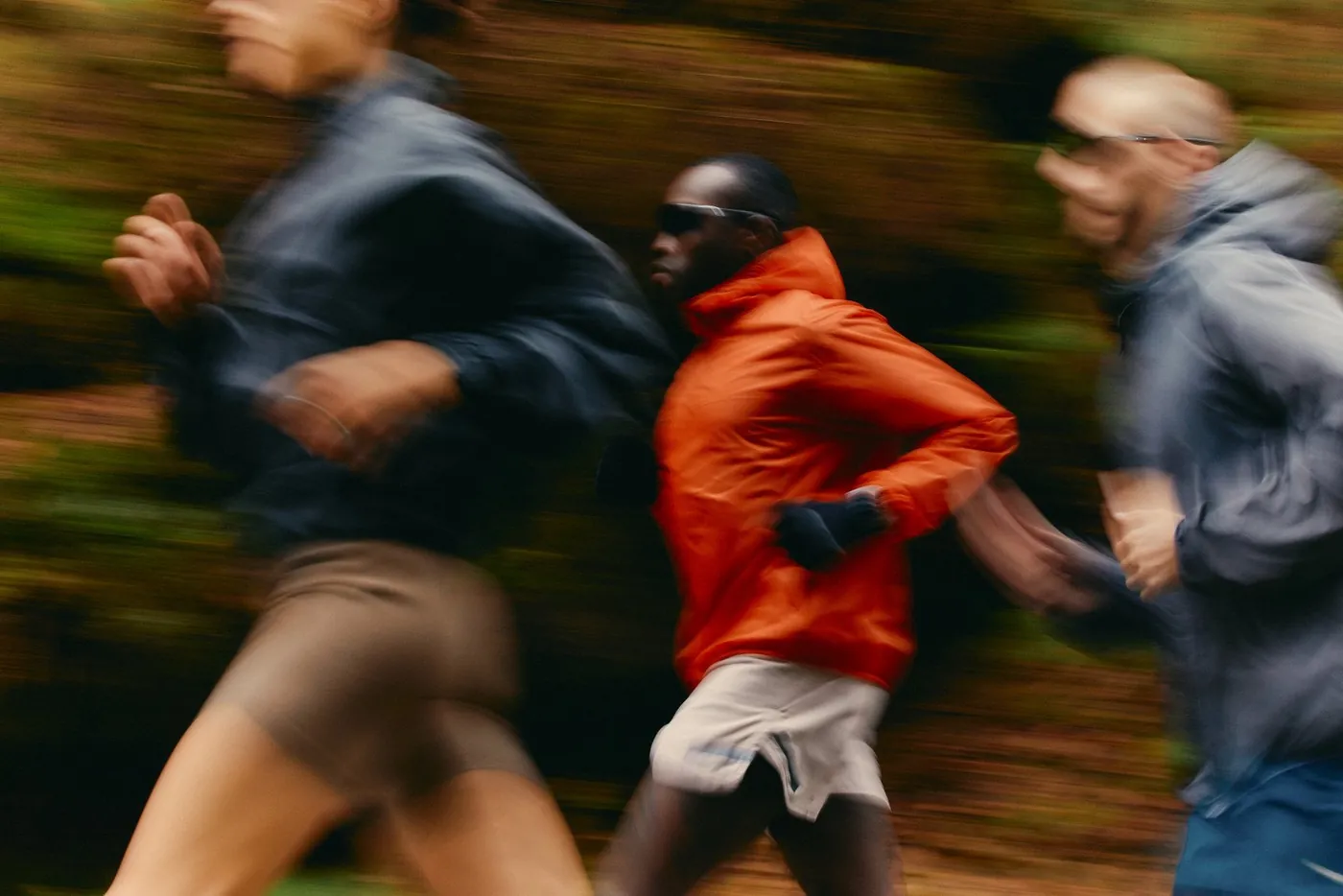 Runners in motion through an autumn forest